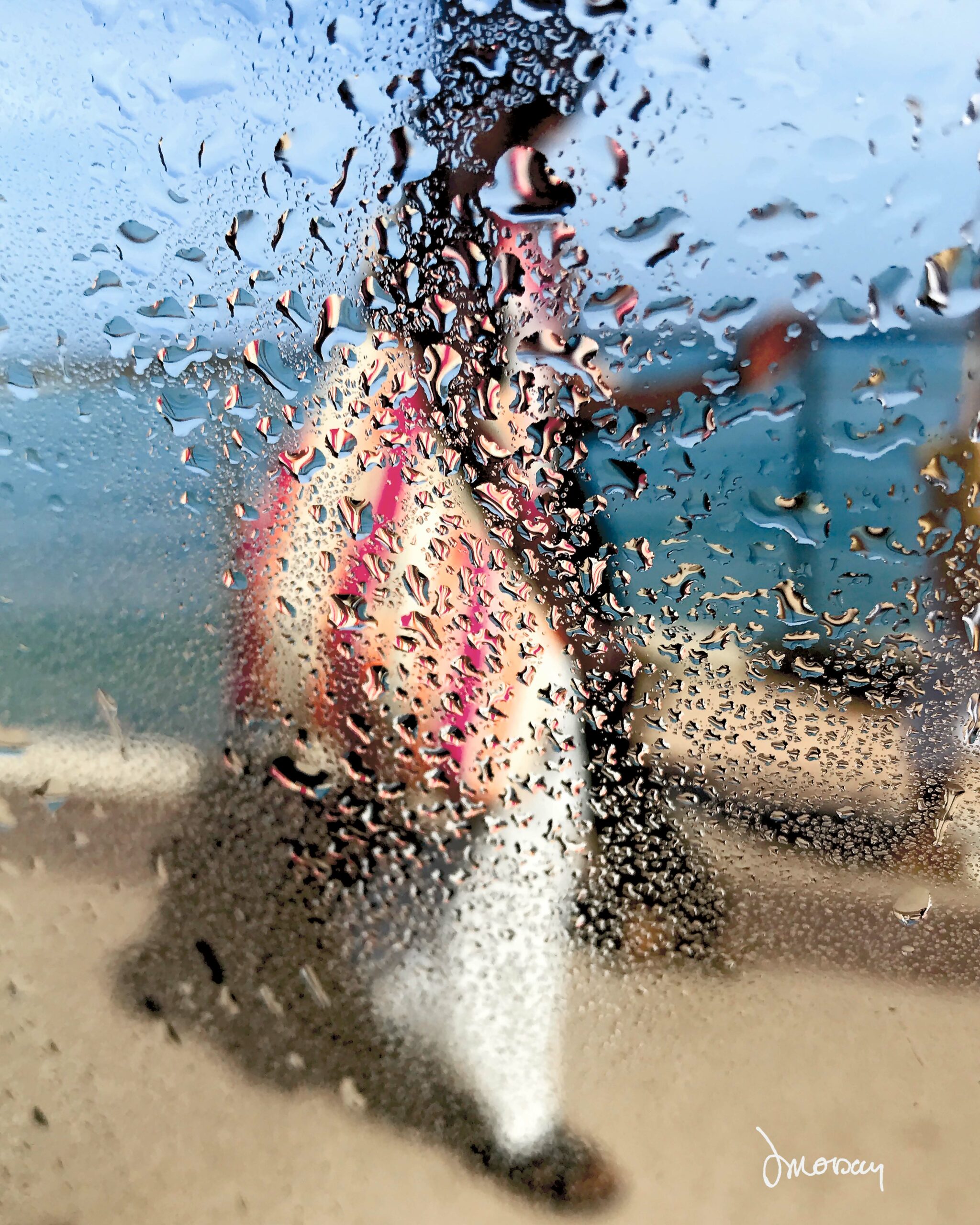 Photographie impressionniste L'africaine de Sophie Moisan, jeune femme tout en couleurs se promenant sur fond de ciel et mer bleue.
