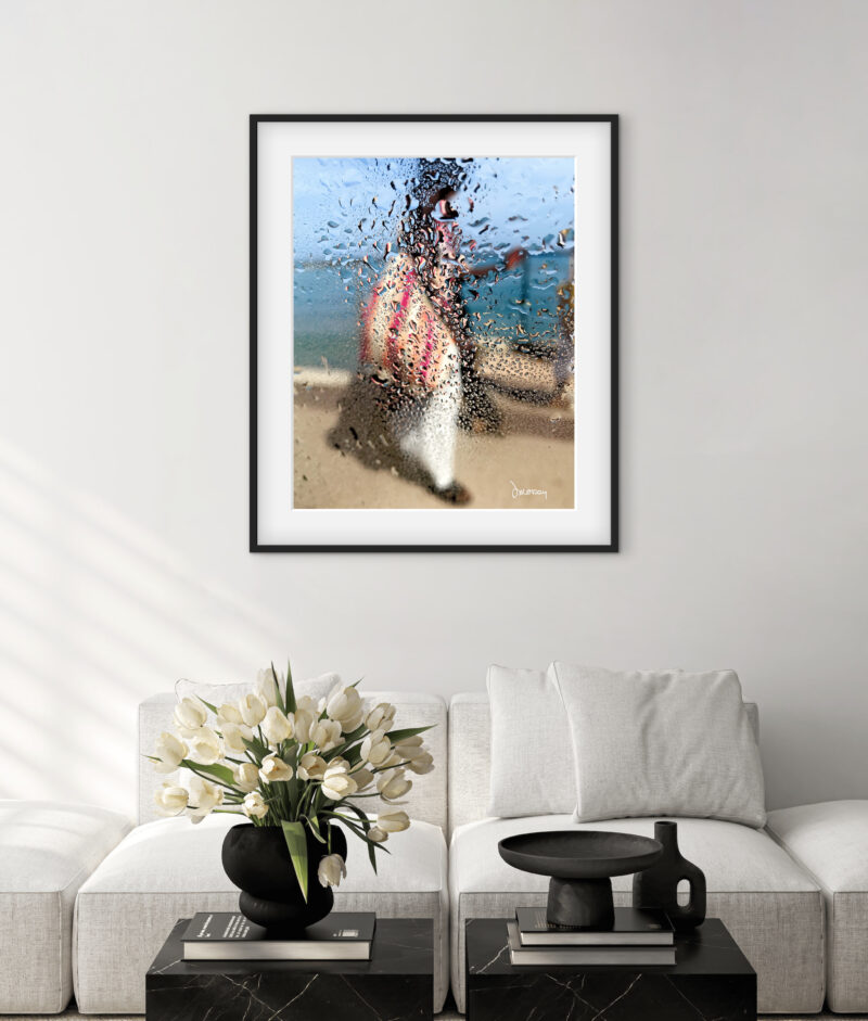 Mise en situation d'une photographie d’art impressionniste de Sophie Moisan dans un salon moderne. Tirage limité, silhouette féminine sous la pluie, mer et ciel bleu - Sophie Moisan